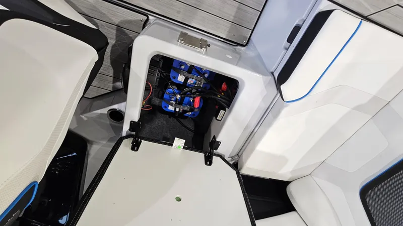 Slide: The Image of 2023 Yamaha Boats 222XD battery compartment with open hatch, showcasing interior components. - 26