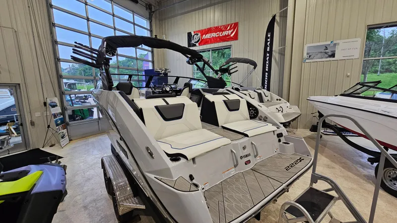 Slide: The Image of 2023 Yamaha Boats 222XD in showroom, featuring sleek design and modern amenities. - 3