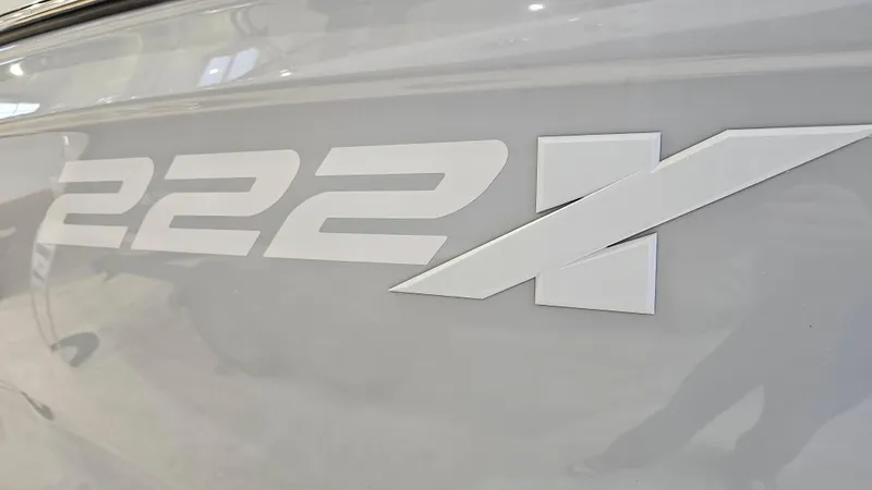 Slide: The Image of Close-up of 2023 Yamaha Boats 222XD model logo on boat exterior. - 30