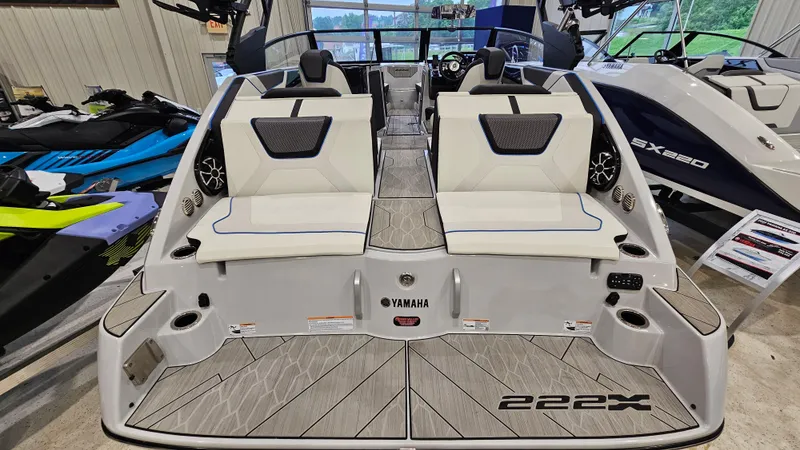 Slide: The Image of 2023 Yamaha Boats 222XD, sleek design, dual seating, modern interior, displayed indoors. - 4