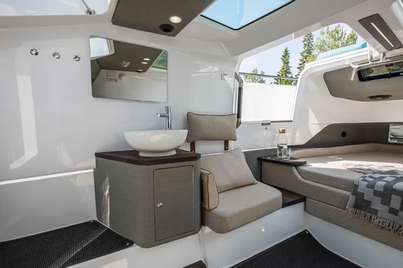 Slide: The Image of 2025 Axopar 37XC CROSS CABIN interior with modern design and comfortable seating. - 10