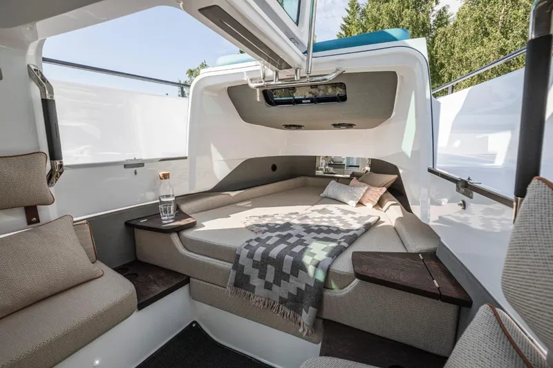 Slide: The Image of 2025 Axopar 37XC CROSS CABIN interior with cozy bed and modern design. - 11