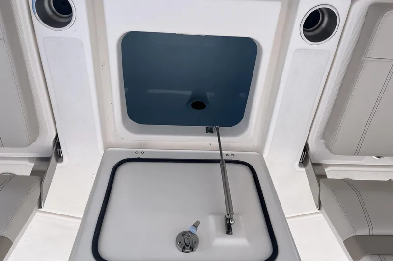 Slide: The Image of 2026 Boston Whaler 250 Dauntless boat interior storage compartment with seating. - 14