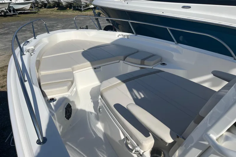 Slide: The Image of 2026 Boston Whaler 250 Dauntless boat interior with cushioned seating and stainless steel railings. - 16