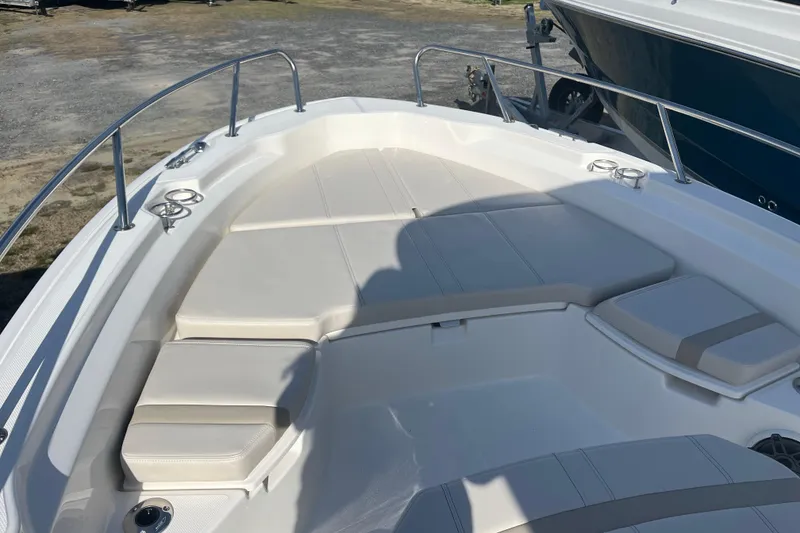 Slide: The Image of 2026 Boston Whaler 250 Dauntless boat deck with cushioned seating and stainless steel railings. - 17
