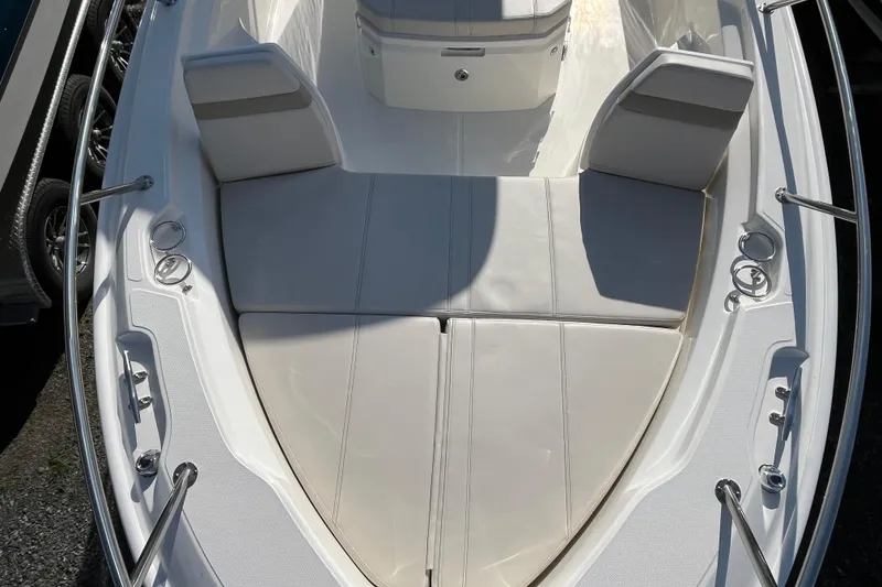 Slide: The Image of 2026 Boston Whaler 250 Dauntless boat interior with cushioned seating and stainless steel fittings. - 19