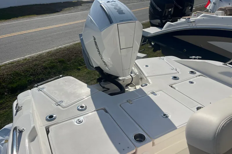 Slide: The Image of 2026 Boston Whaler 250 Dauntless boat with Mercury outboard engine, docked on a sunny day. - 21