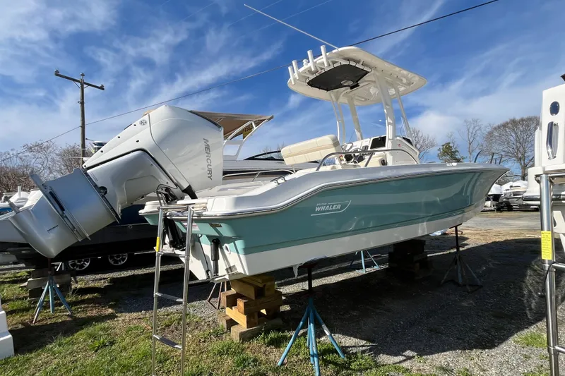Slide: The Image of 2026 Boston Whaler 250 Dauntless boat with Mercury engine on display outdoors. - 24