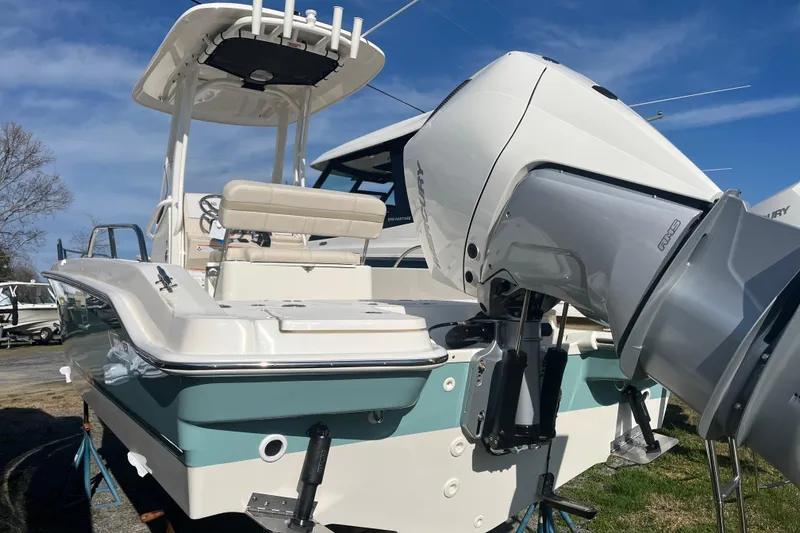 Slide: The Image of 2026 Boston Whaler 250 Dauntless boat with powerful outboard motor, docked outdoors. - 27