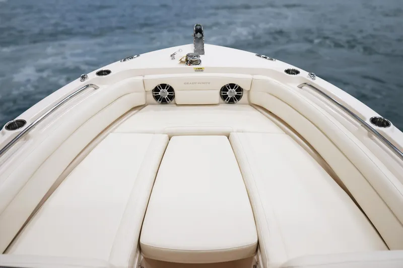 Slide: The Image of 2025 Grady-White 235 Freedom boat interior with cushioned seating and ocean backdrop. - 17
