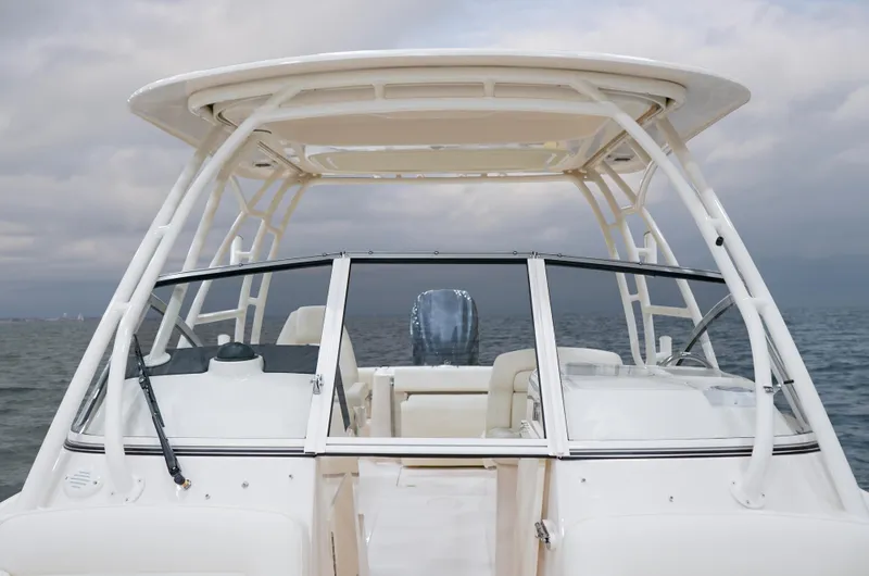 Slide: The Image of 2025 Grady-White 235 Freedom boat on open water, featuring sleek design and spacious seating. - 3