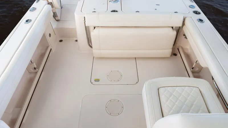 Slide: The Image of 2025 Grady-White 235 Freedom boat interior with cushioned seating and storage compartments. - 6