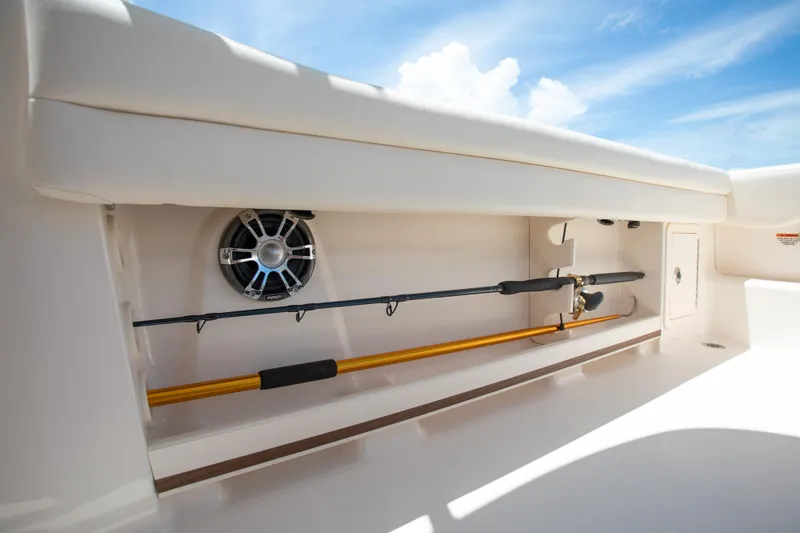 Slide: The Image of Storage compartment on 2025 Grady-White 235 Freedom boat with fishing rod and speaker. - 7