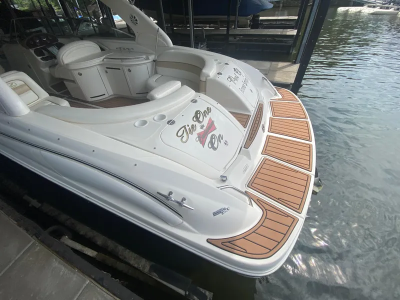Slide: The Image of 2003 Sea Ray 290 Bowrider docked, featuring spacious seating and elegant design. - 10