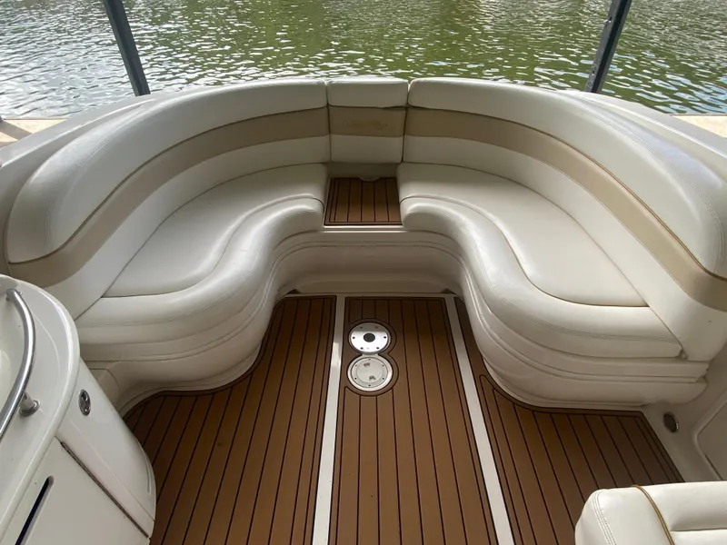 Slide: The Image of Luxurious seating area on 2003 Sea Ray 290 Bowrider, featuring elegant white upholstery. - 13