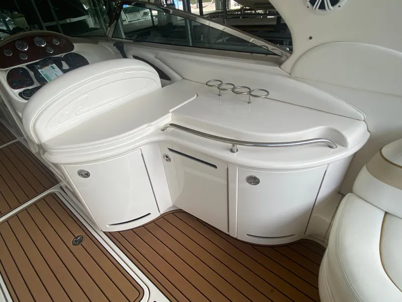 Slide: The Image of 2003 Sea Ray 290 Bowrider interior with white cabinetry and wood-style flooring. - 15