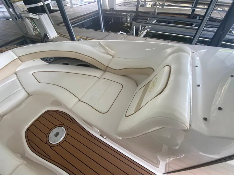 Slide: The Image of 2003 Sea Ray 290 Bowrider interior with white seating and wood-style flooring. - 29