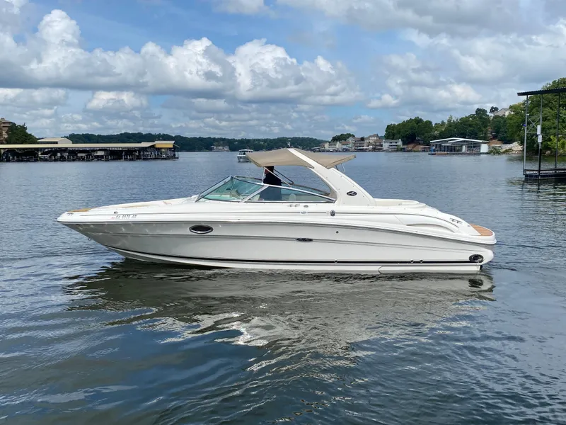 Slide: The Image of 2003 Sea Ray 290 Bowrider on a calm lake under a partly cloudy sky. - 3
