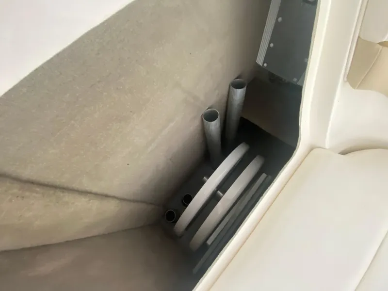 Slide: The Image of Storage compartment in a 2003 Sea Ray 290 Bowrider boat, featuring pipes and equipment. - 30