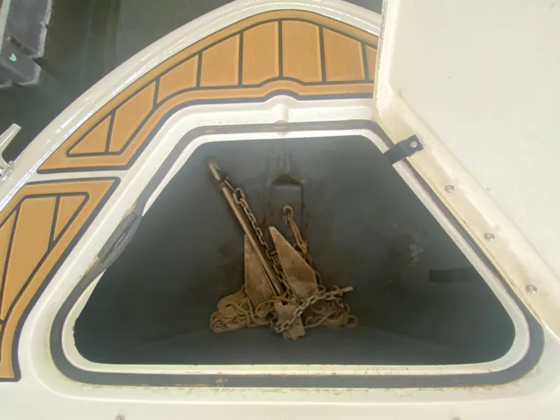 Slide: The Image of Anchor storage compartment on a 2003 Sea Ray 290 Bowrider boat. - 31