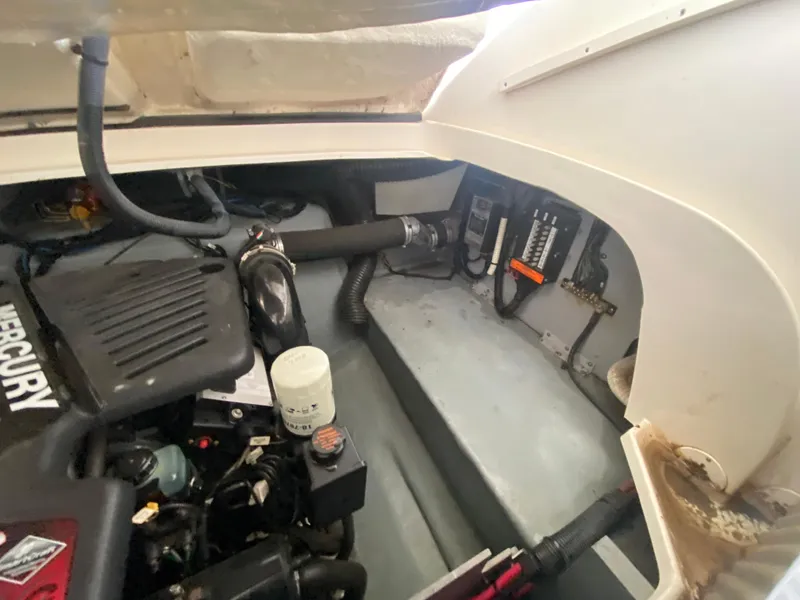 Slide: The Image of Engine compartment of a 2003 Sea Ray 290 Bowrider boat, featuring Mercury components. - 34