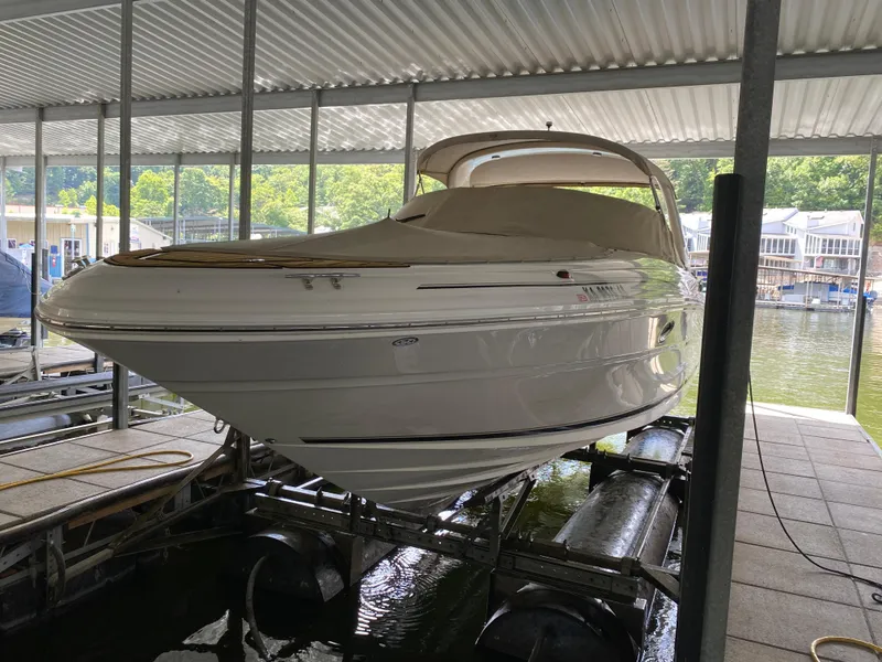 Slide: The Image of 2003 Sea Ray 290 Bowrider on a lift in a covered dock. - 36