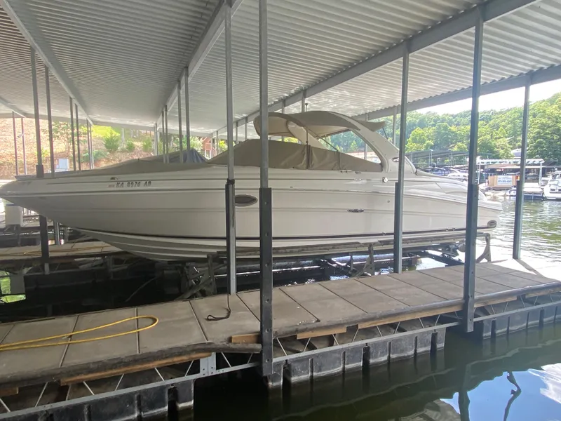 Slide: The Image of 2003 Sea Ray 290 Bowrider docked under covered marina. - 37