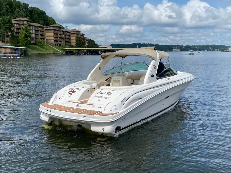 Slide: The Image of 2003 Sea Ray 290 Bowrider on a scenic lake with buildings in the background. - 7