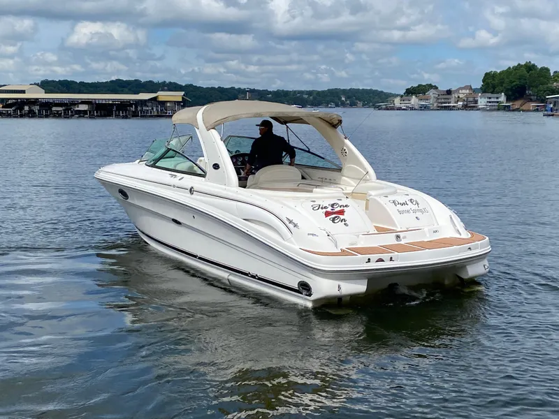 Slide: The Image of 2003 Sea Ray 290 Bowrider cruising on a lake with scenic background. - 8