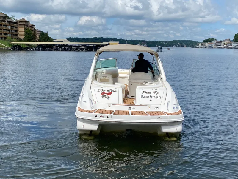 Slide: The Image of 2003 Sea Ray 290 Bowrider on a lake, with a person steering. - 9