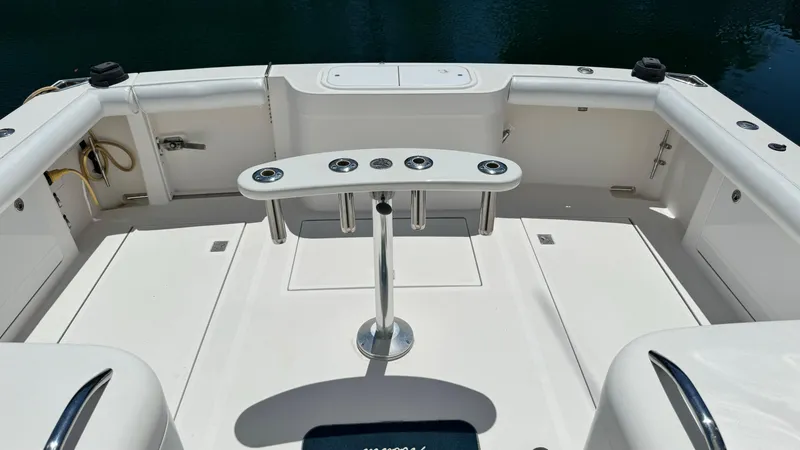 Slide: The Image of 2005 Cabo 35 Express boat deck with rod holders and storage compartments. - 5