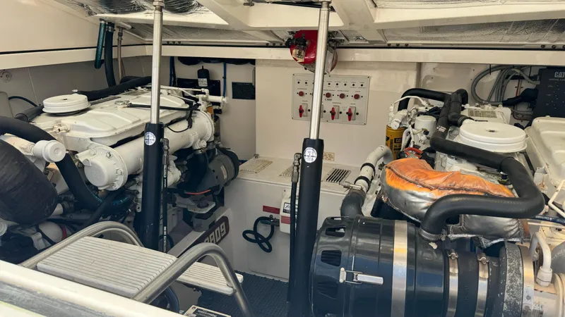 Slide: The Image of Engine room of a 2005 Cabo 35 Express boat, showcasing dual engines and control systems. - 8