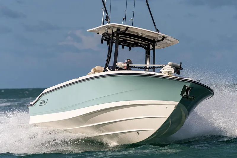 Slide: The Image of 2026 Boston Whaler 280 Dauntless boat, docked, showcasing spacious seating and sleek design. - 12