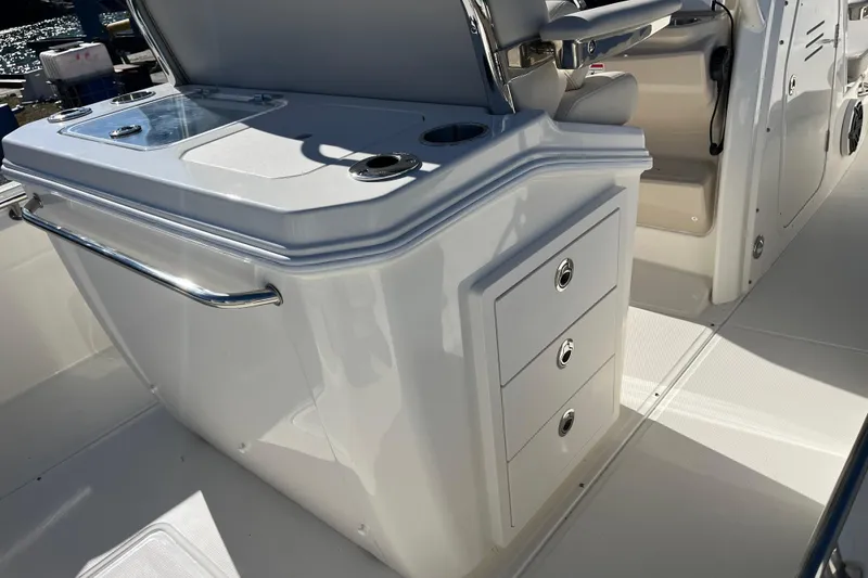 Slide: The Image of 2026 Boston Whaler 280 Dauntless boat interior with storage drawers and seating. - 21