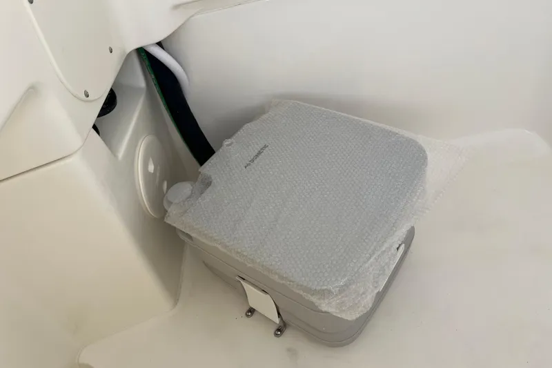 Slide: The Image of Portable toilet in 2026 Boston Whaler 280 Dauntless boat, covered with bubble wrap. - 23