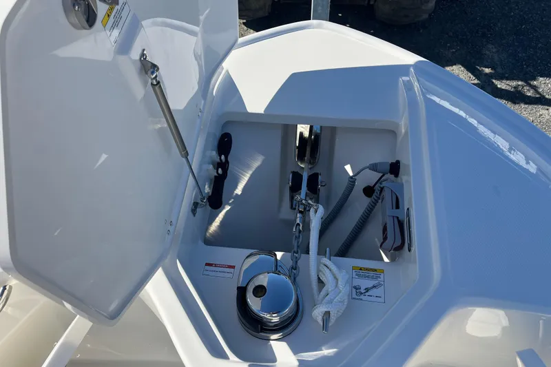 Slide: The Image of Anchor compartment of 2026 Boston Whaler 280 Dauntless, featuring storage and equipment. - 24