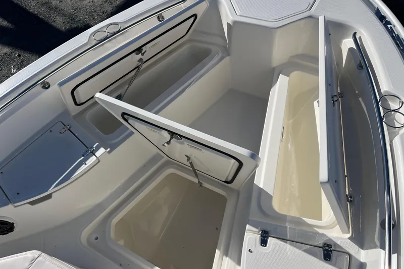 Slide: The Image of 2026 Boston Whaler 280 Dauntless boat storage compartments open, showcasing spacious interior design. - 25