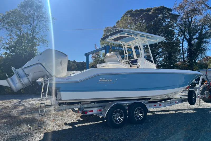 Slide: The Image of 2026 Boston Whaler 280 Dauntless boat on trailer, parked outdoors under clear blue sky. - 30