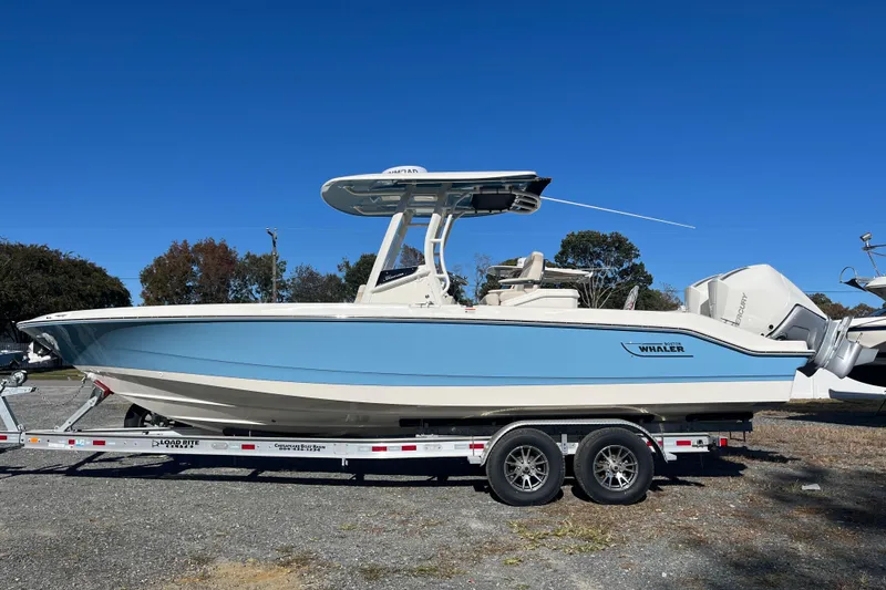 Slide: The Image of 2026 Boston Whaler 280 Dauntless boat on trailer, side view, clear blue sky. - 31