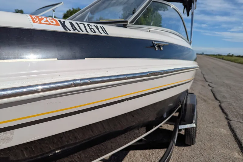 Slide: The Image of 2006 Tahoe Q6 Sport boat on trailer, close-up side view, outdoors. - 13