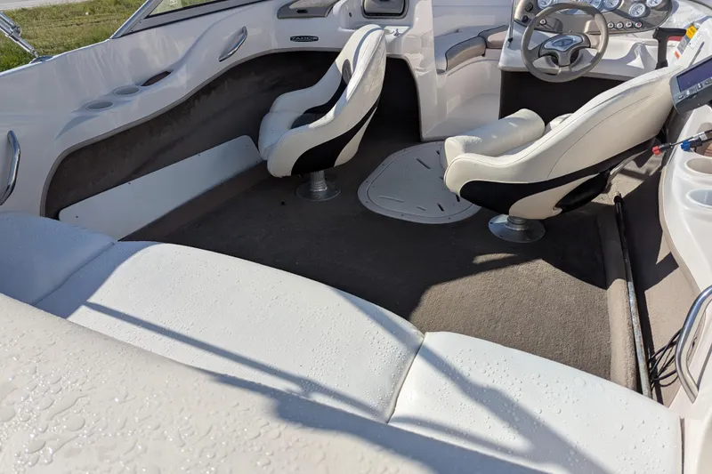 Slide: The Image of Interior of a 2006 Tahoe Q6 Sport boat with white seating and steering wheel. - 15
