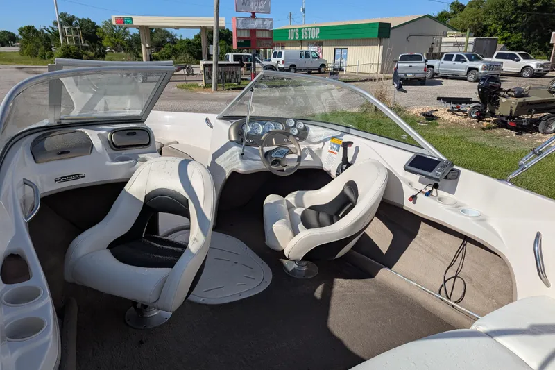 Slide: The Image of 2006 Tahoe Q6 Sport boat interior with white seating and dashboard controls. - 18