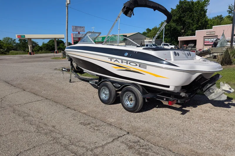 Slide: The Image of 2006 Tahoe Q6 Sport boat on trailer in parking lot, sunny day. - 2