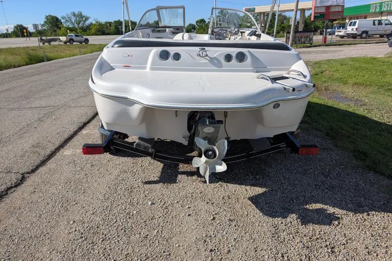 Slide: The Image of 2006 Tahoe Q6 Sport boat, rear view, parked on gravel near road. - 4