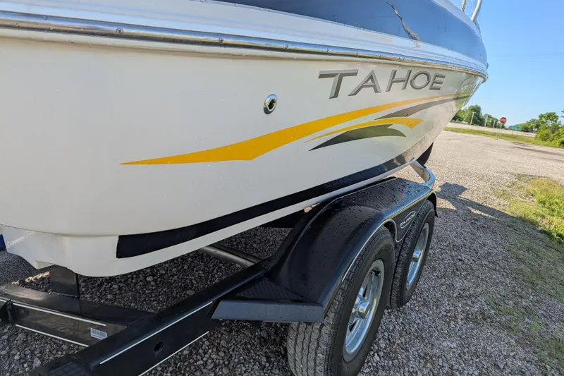 Slide: The Image of 2006 Tahoe Q6 Sport boat on trailer, side view with yellow and black graphics. - 6