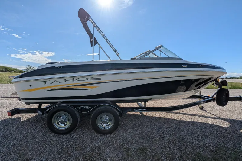 Slide: The Image of 2006 Tahoe Q6 Sport boat on trailer under clear blue sky. - 8