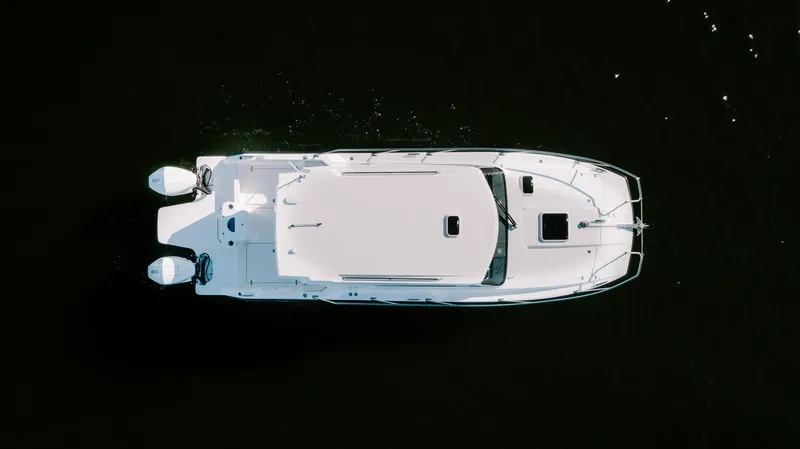 Slide: The Image of Aerial view of 2025 ArrowCat 320 boat on dark water. - 10