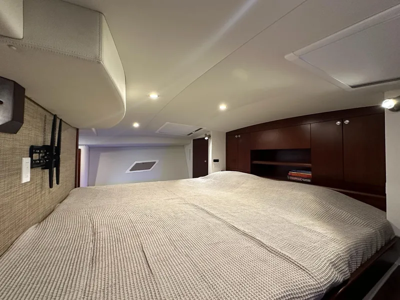 Slide: The Image of Luxurious cabin interior of 2025 ArrowCat 420 Coupe with cozy bed and elegant wood cabinetry. - 7