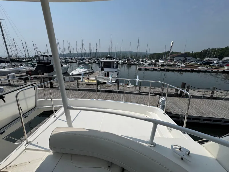 Slide: The Image of 2003 Cruisers Yachts 5000 Sedan Sport docked at a marina with other boats. - 15