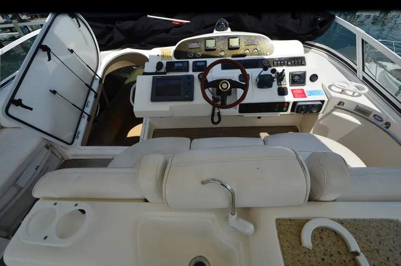 Slide: The Image of 2003 Cruisers Yachts 5000 Sedan Sport helm with steering wheel and navigation controls. - 17